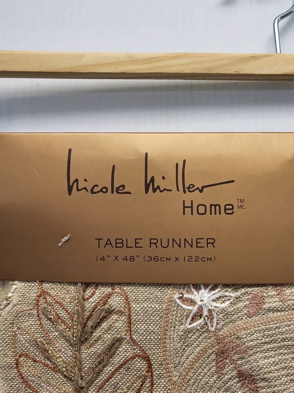 Nicole Miller Home beaded table runner featuring a festive fall pumpkin and leaf